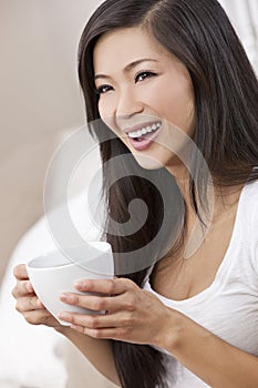 Beautiful Oriental Woman Drinking Tea or Coffee