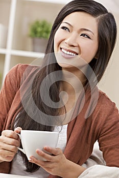 Beautiful Oriental Woman Drinking Tea or Coffee