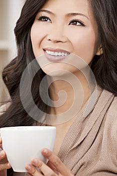 Beautiful Oriental Woman Drinking Tea or Coffee