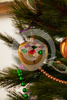 Beautiful original toy weighs on Christmas tree close-up