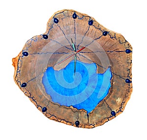 Beautiful original wooden wall clock made of tree root and blue epoxy isolated on a white background photo