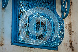 Beautiful ornamental blue windows on a white wall so typical for