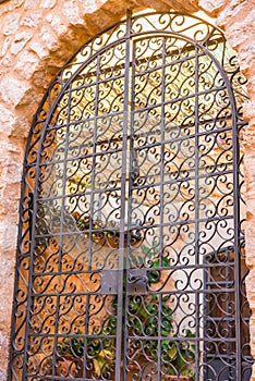 Beautiful ornated iron gate of mediterranean house entrance