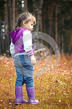 Beautiful outdoor autumn portrait of adorable toddler girl