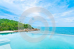 Beautiful outdoor infinity swimming pool in hotel resort with sea ocean view and white cloud blue sky