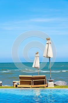 Beautiful outdoor nature landscape with bed deck chair around swimming pool in hotel resort