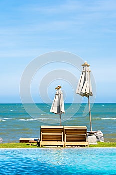 Beautiful outdoor nature landscape with bed deck chair around swimming pool in hotel resort