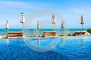 Beautiful outdoor nature landscape with bed deck chair around swimming pool in hotel resort