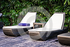 Beautiful outdoor swimming pool with bed deck chair and umbrella in resort for travel and vacation