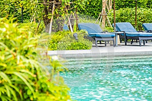 Beautiful outdoor swimming pool in hotel and resort with chair and deck for leisure vacation