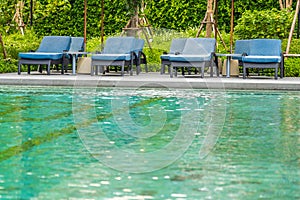 Beautiful outdoor swimming pool in hotel and resort with chair and deck for leisure vacation