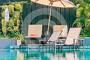 Beautiful outdoor swimming pool in hotel and resort with chair and deck for leisure vacation