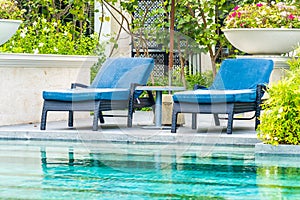 Beautiful outdoor swimming pool in hotel and resort with chair and deck for leisure vacation