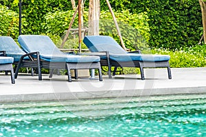 Beautiful outdoor swimming pool in hotel and resort with chair and deck for leisure vacation