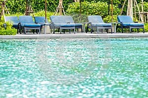 Beautiful outdoor swimming pool in hotel and resort with chair and deck for leisure vacation