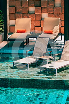 Beautiful outdoor swimming pool in hotel and resort with chair and deck for leisure vacation