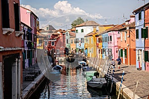 Beautiful outdoor view of boats docked on the canal and colorful buildings on the sides