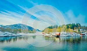 Beautiful outdoor view of wooden houses in a coastal scene on Hurtigruten trip