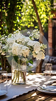 Beautiful outdoor wedding table setting with white flowers