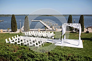 Beautiful outgoing wedding set up. Jewish Hupa  on romantic wedding ceremony , wedding outdoor on the lawn water view. Wedding