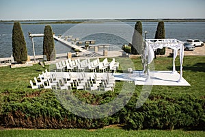 Beautiful outgoing wedding set up. Jewish Hupa  on romantic wedding ceremony , wedding outdoor on the lawn water view. Wedding