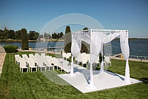 Beautiful outgoing wedding set up. Jewish Hupa  on romantic wedding ceremony , wedding outdoor on the lawn water view. Wedding