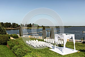 Beautiful outgoing wedding set up. Jewish Hupa  on romantic wedding ceremony , wedding outdoor on the lawn water view. Wedding