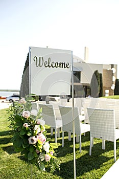 Beautiful outgoing wedding set up. Romantic wedding ceremony , wedding outdoor on the lawn water view. Wedding decor. White wooden