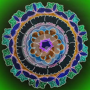 Beautiful painted mandala on green background