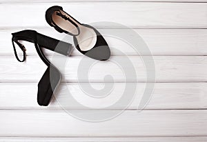 Beautiful Pair Black Female Shoes on White Wood Background with Copy Space. Fashion Style for Woman. Stylish Footwear