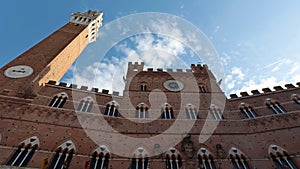 The beautiful Palazzo Pubblico with the Torre del Mangia located in Piazza del Campo in the historic center of Siena.
