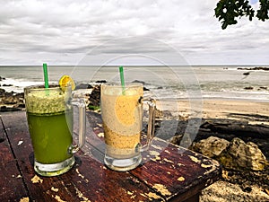 Beautiful palm tree lined mangroves drinks on the beach shoreline beach in Santa teresa, Costa Rica.