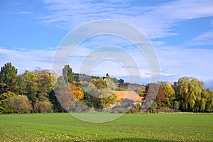 beautiful panorama of an autum landscape with coloured trees and windmills in germany