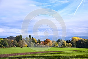 beautiful panorama of an autum landscape with coloured trees and windmills in germany