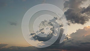 A beautiful panorama of a dark evening sky with blue clouds in the sunlight.