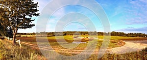 Beautiful panorama of a golden autmun landscape with trees and a blue sky