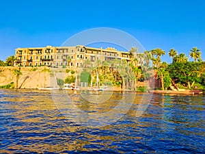 Beautiful panorama landscape with felucca boats on Nile river in Aswan at sunset