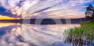 Beautiful panorama landscape with sunrise over the water lake