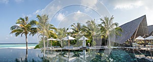 Beautiful panorama landscape view of infinity pool at the tropical island luxury resort