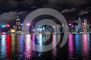 Beautiful panorama scene of hong kong city midtown at night with skyscrapers illuminated reflecting in the river