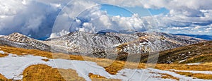 Beautiful panorama of snow covered Australian Alps and yellow gr