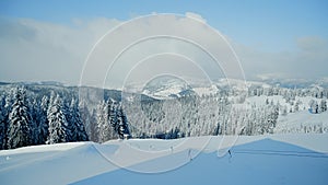 Beautiful panorama of snowy mountains landscape with snow covered forest