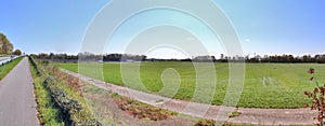 Beautiful panorama of spring landscapes with green grass and a clear blue sky