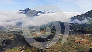Beautiful Panorama Top view of growing golden paddy rice field in Tavan local village with fansipan mountain and cloudy