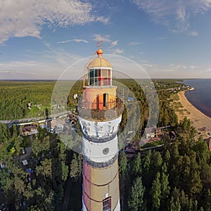 Beautiful panorama with a view of the lighthouse and the shore with water in the Leningrad region, Russia