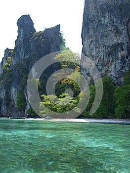 A beautiful panorama view with rocks, crystal clear water and white sandy beach in Thailand.
