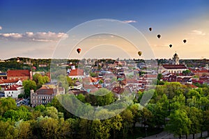 Beautiful panorama of Vilnius old town with hot air balloons in the sky