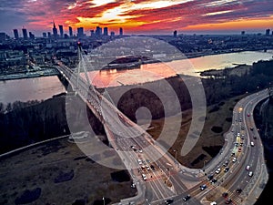 Beautiful panoramic aerial drone sunset view to Warsaw city center with skyscrapers and Swietokrzyski Bridge En: Holy Cross