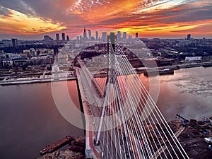 Beautiful panoramic aerial drone sunset view to Warsaw city center with skyscrapers and Swietokrzyski Bridge En: Holy Cross