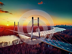 Beautiful panoramic aerial drone view to cable-stayed Siekierkowski Bridge over the Vistula river and Warsaw City skyscrapers,